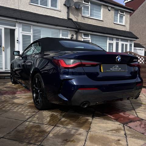 Rear of a dark blue BMW 420i convertible after a full valet