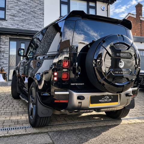 Rear of a black Land Rover Defender with a deep gloss finish after a full valet