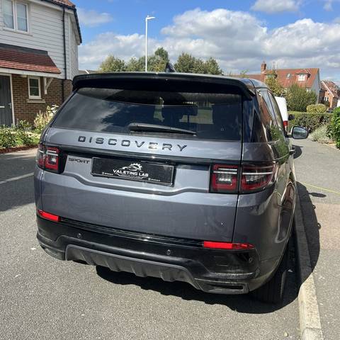Rear of a grey Land Rover Discovery Sport cleaned on a residential driveway