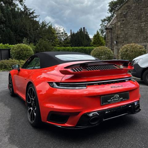 Rear of a Guards Red Porsche 911 Turbo S convertible gleaming after an Elite Valet
