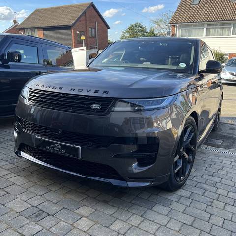 Dark grey Range Rover Sport gleaming on a block paved driveway after a valet