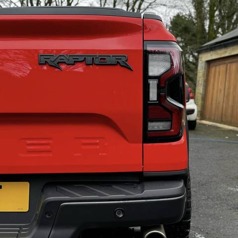 Rear of a red Ford Raptor pickup after a full valet